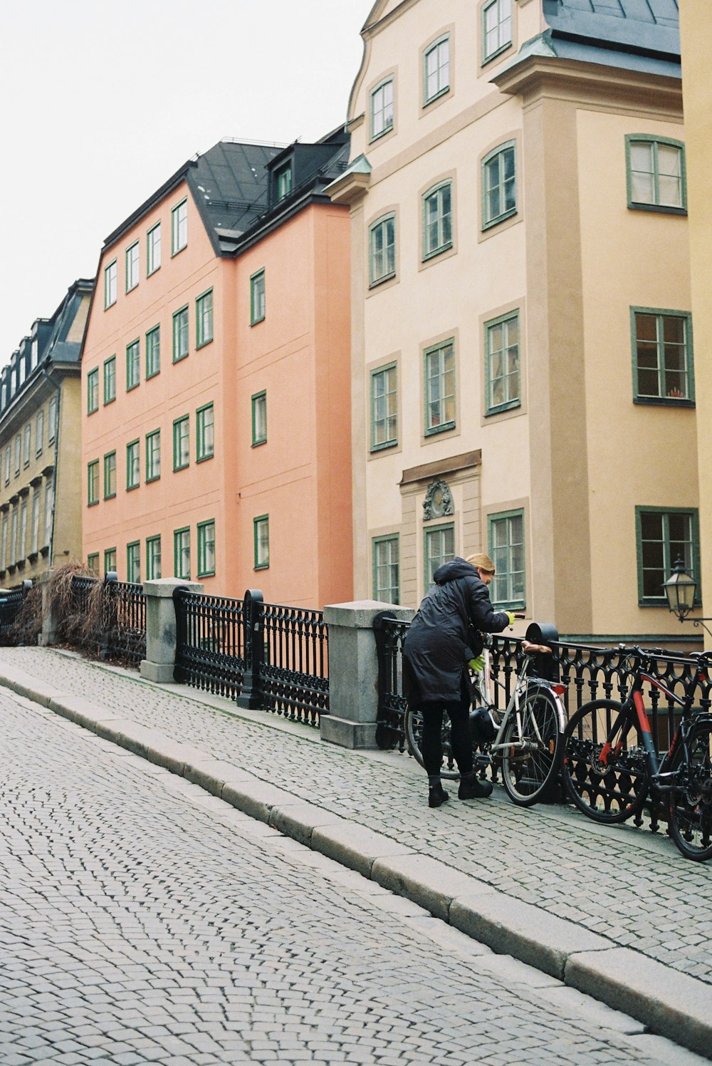 a person standing next to a row of bicycles