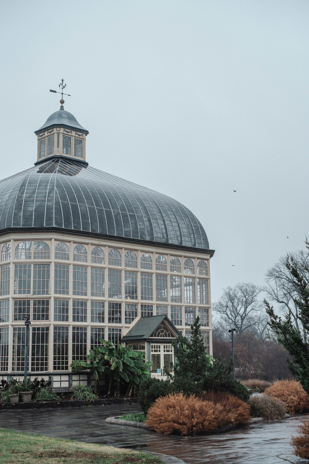 a large glass building with a steeple on top of it