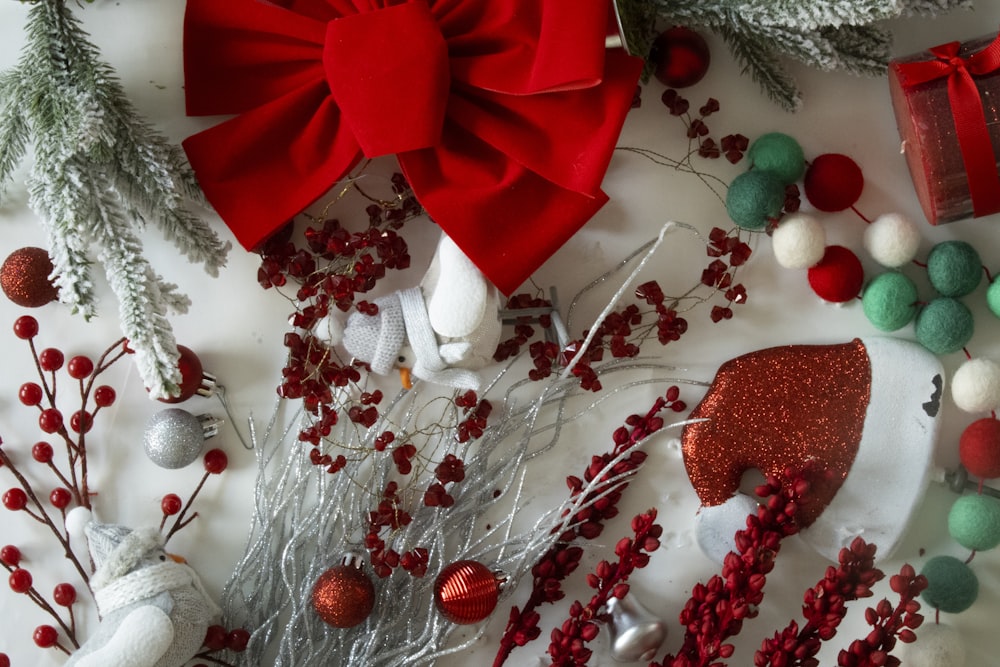 a red bow and a white bow on a white surface