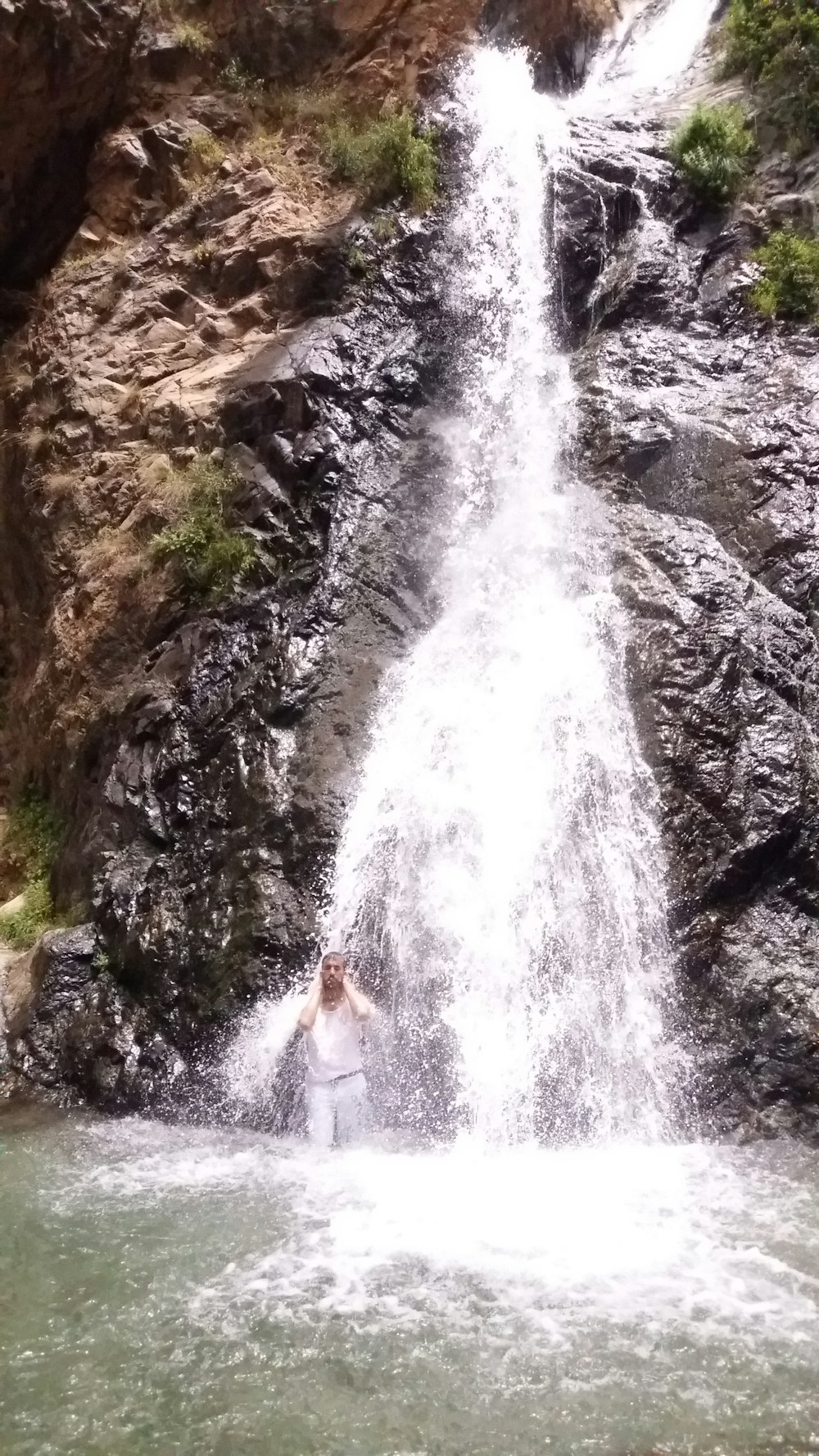 a person standing in front of a waterfall