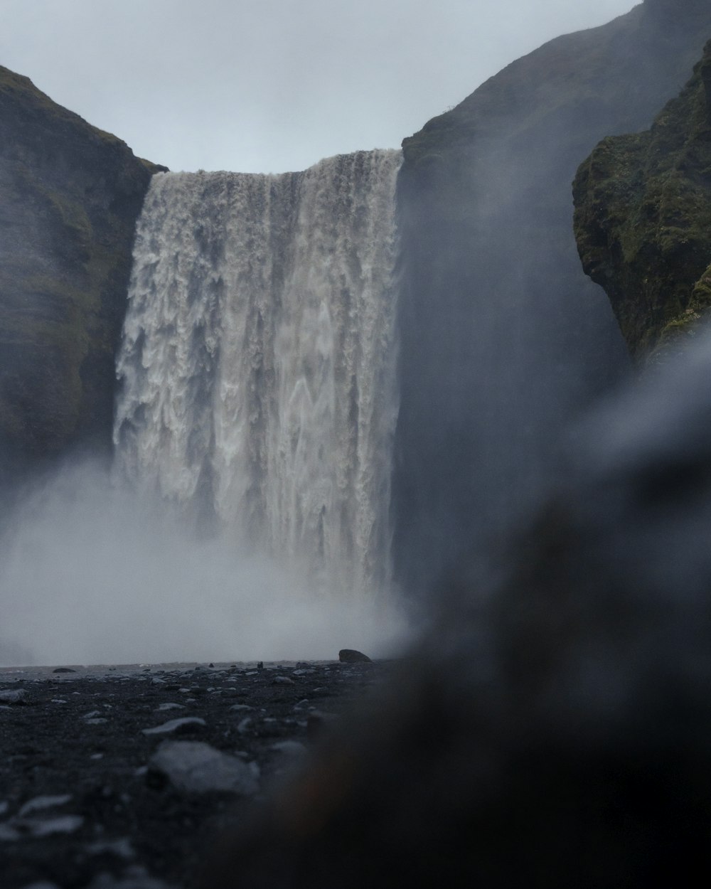 a waterfall with a rainbow