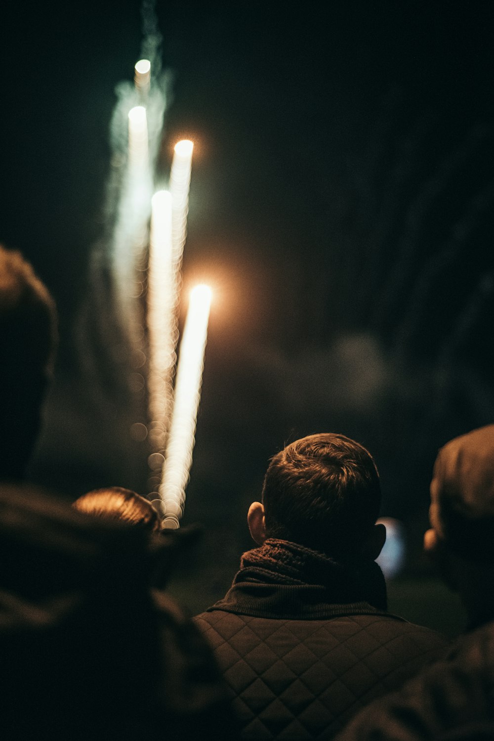a group of people watching fireworks