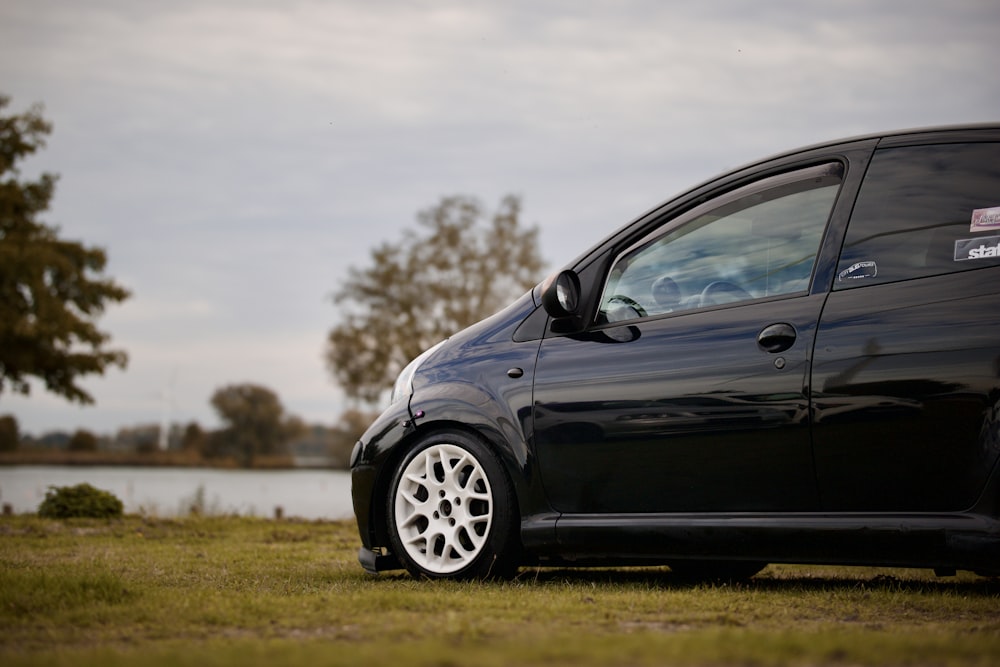 a black car parked on grass