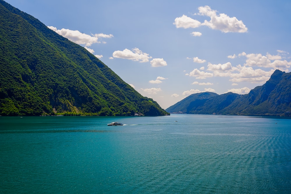 a body of water with mountains in the background