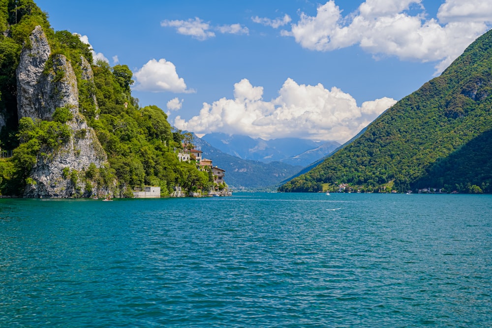 a body of water with trees and mountains around it