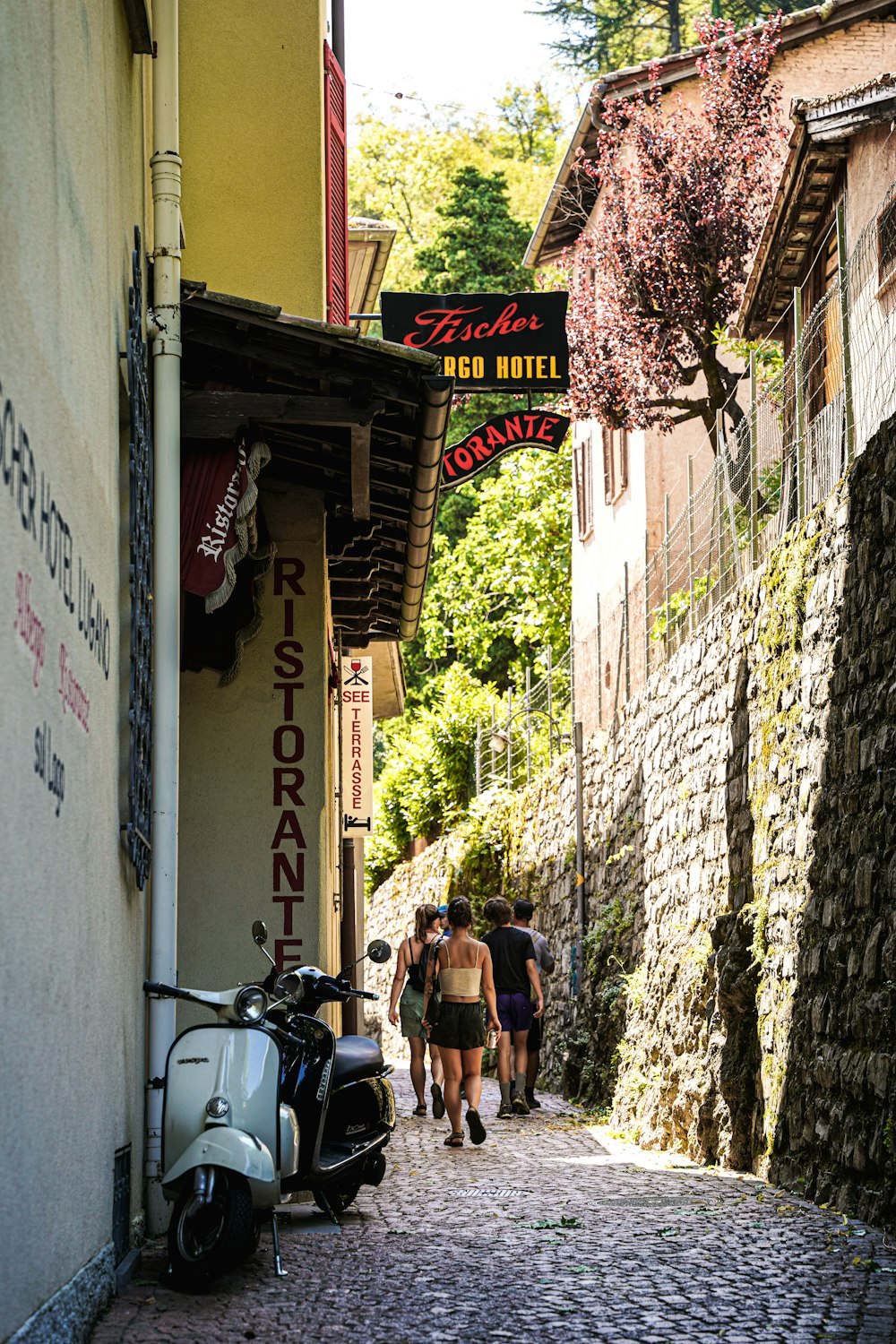 people walking down a narrow street