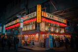 A lively group enjoying their meal at Japones, surrounded by vibrant neon signs and dark stylish walls.