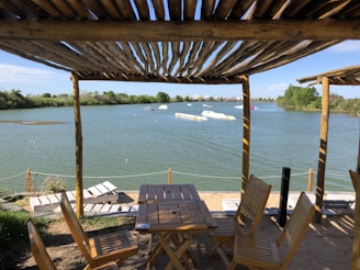 A serene lakeside view with tall trees and a cozy outdoor cooking setup in Istanbul.