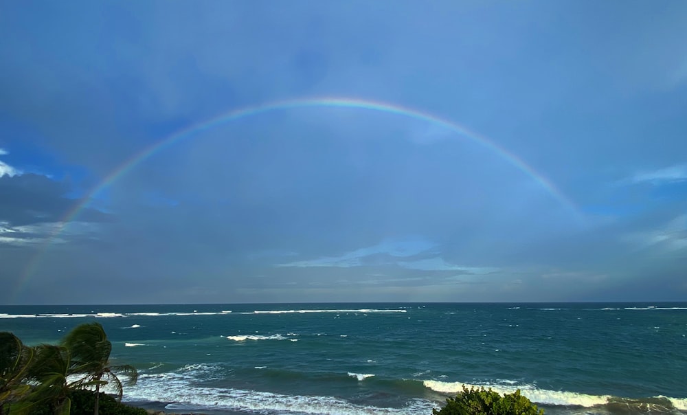 a rainbow over the ocean