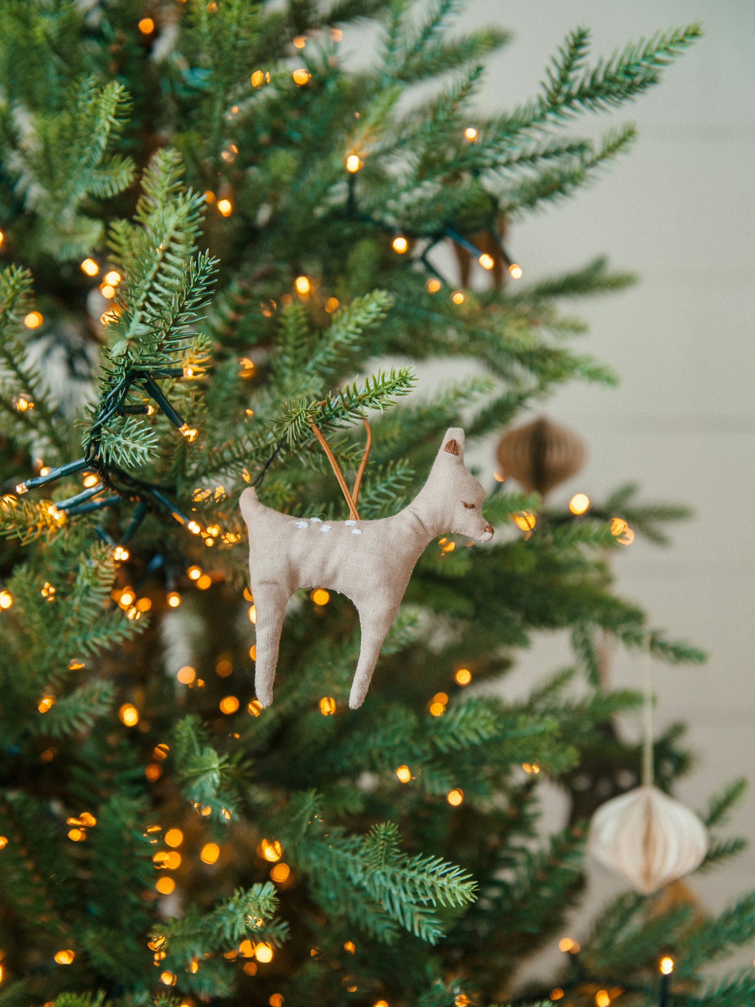 a tree with lights and a dog on it