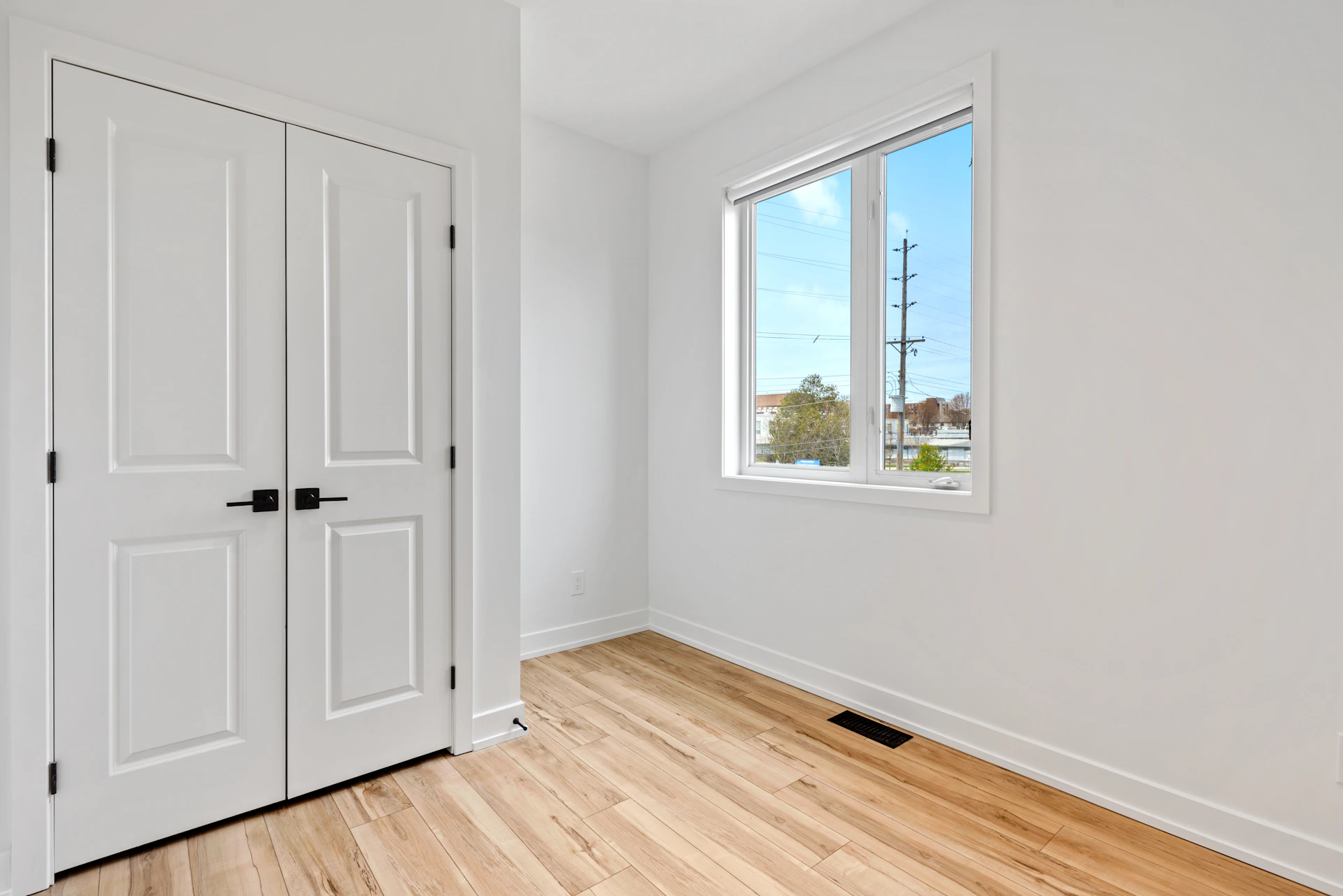 a room with white doors and a window