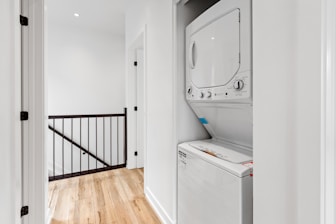 a white room with a mirror and a washer