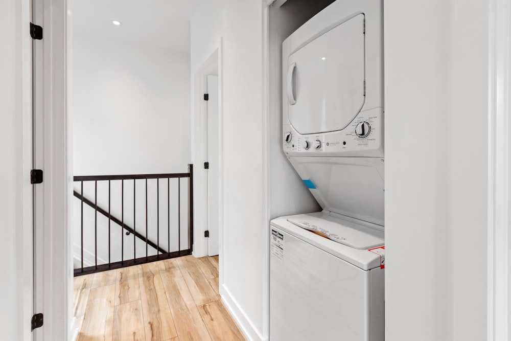 a white room with a mirror and a washer