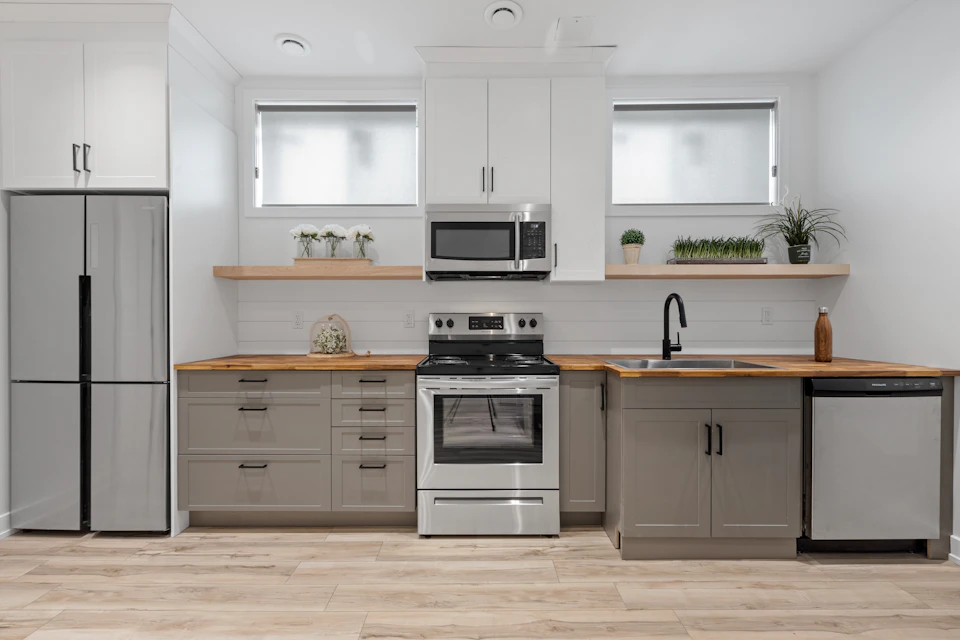 Luxury kitchen with white cabinetry and built-in appliances