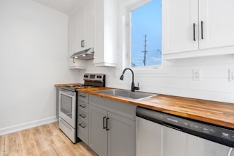 a kitchen with white cabinets