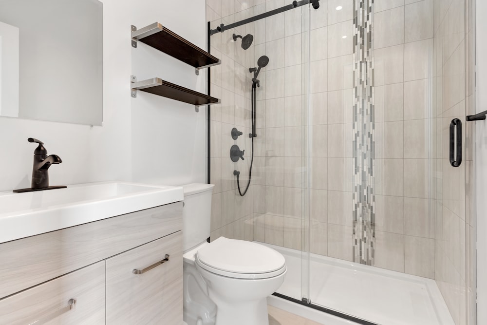 a bathroom with a shower unit and toilet
