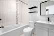 a bathroom with a tub toilet and sink