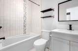 a bathroom with a tub toilet and sink