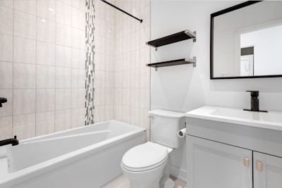 a bathroom with a tub toilet and sink