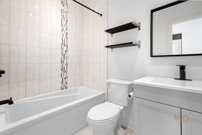 a bathroom with a tub toilet and sink