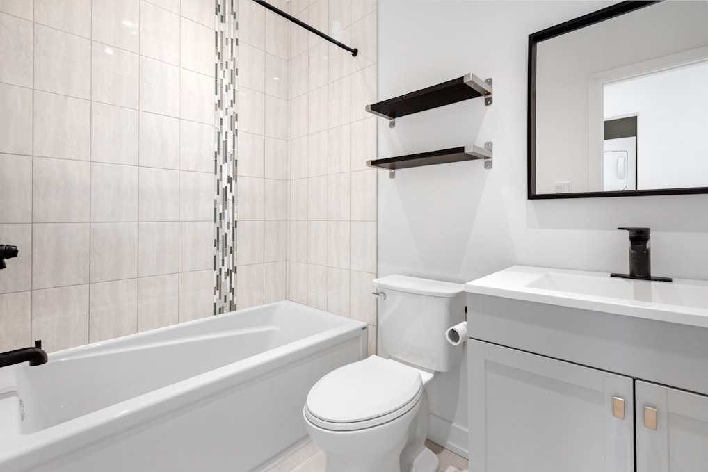 a bathroom with a tub toilet and sink