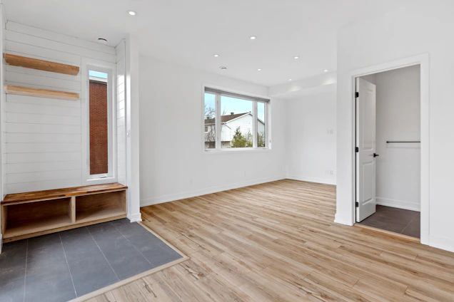 a room with a wood floor and a bench