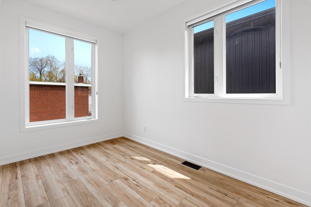 a room with windows and a wood floor