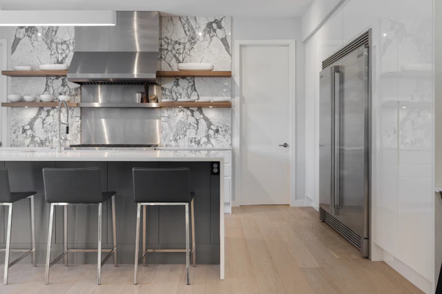 A kitchen with a bar stools
