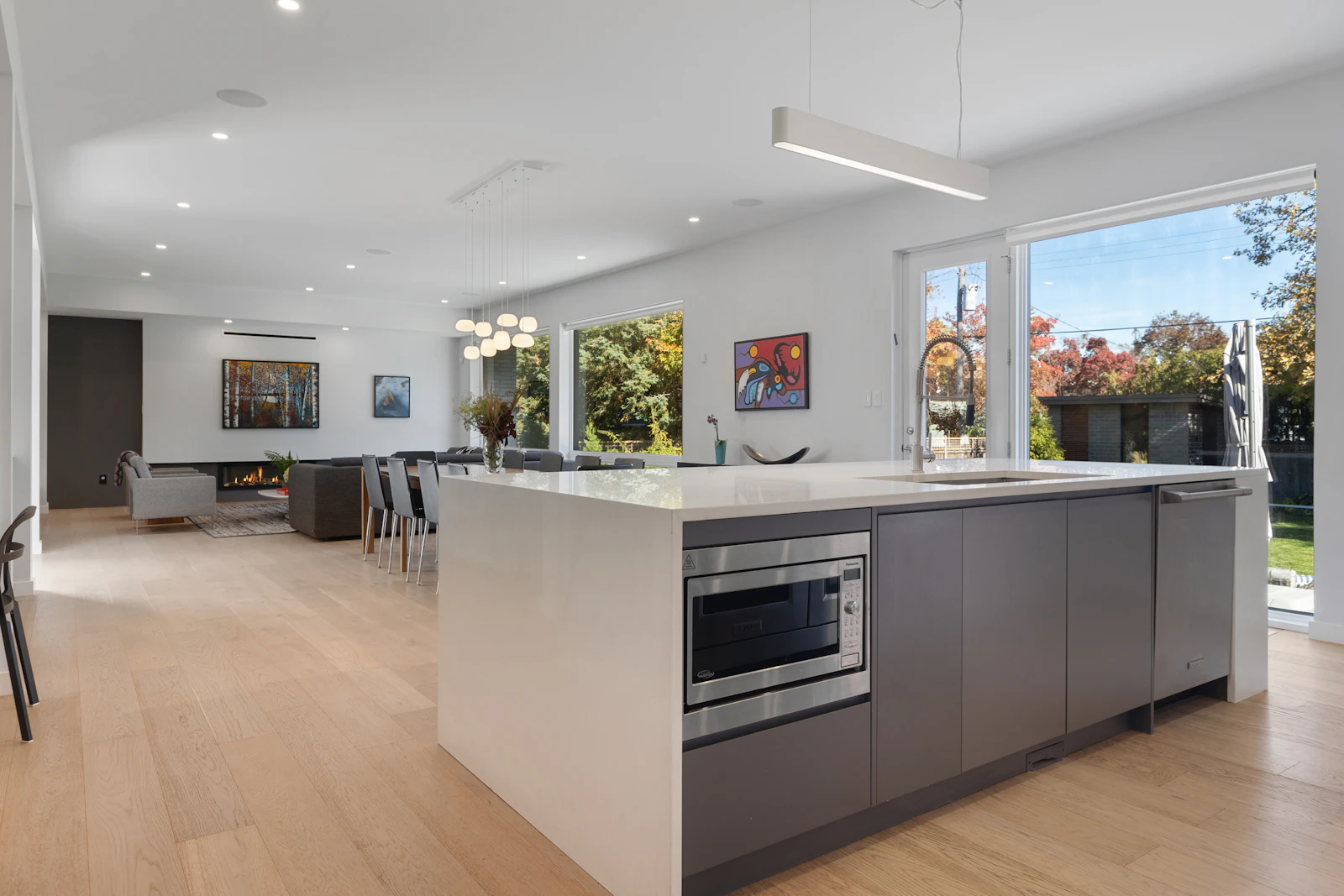 Open-plan kitchen with a large island and windows onto the garden