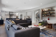 Bright, airy living room with crisp white walls and dark grey furnishings.