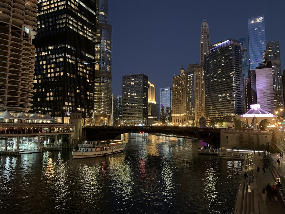 a river with a boat in it and a city in the background