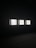 Three illuminated screens are set against a dark background, each displaying hand-drawn illustrations of various objects or scenes. The images on the screens appear to be simplistic line drawings, possibly resembling abstract art or sketches.