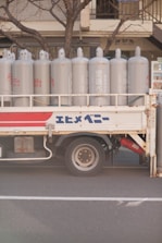 a truck with white barrels on the back