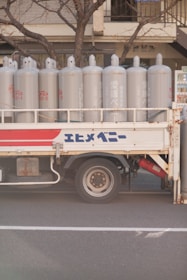 a truck with white barrels on the back
