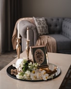 a table with a plate of food and candles on it