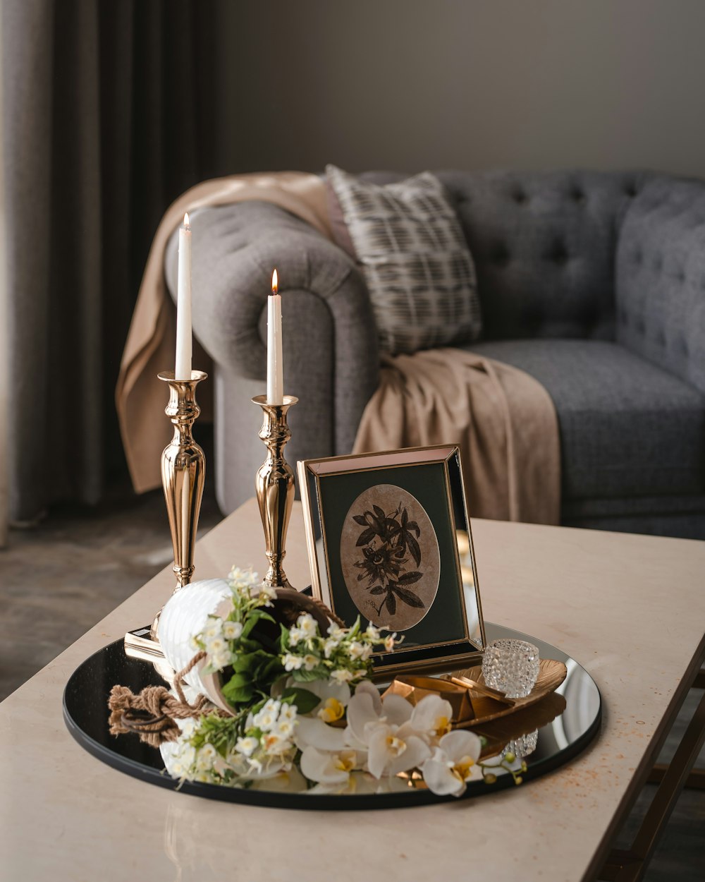 a table with a plate of food and candles on it