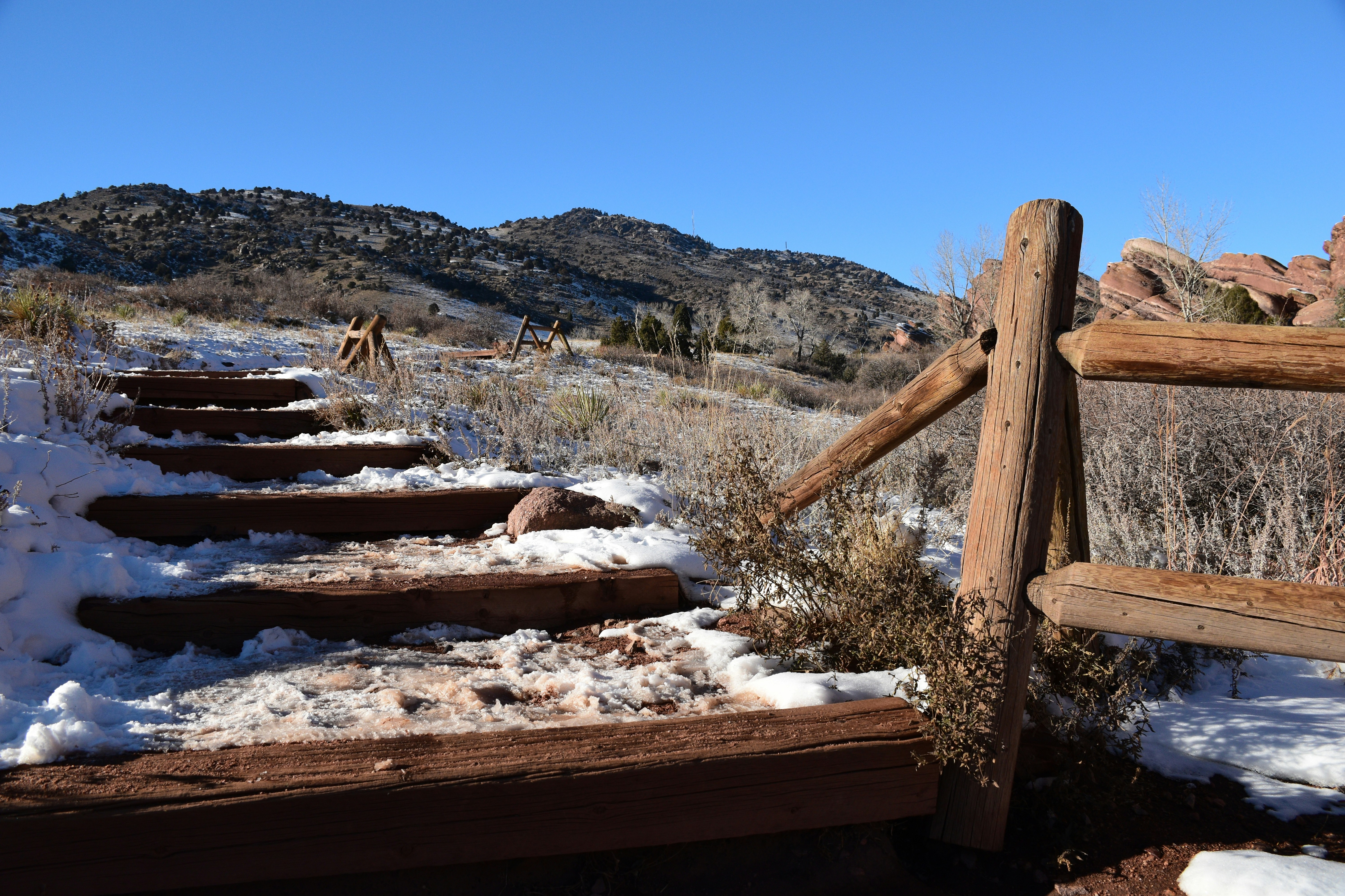 a snowy field with a fence