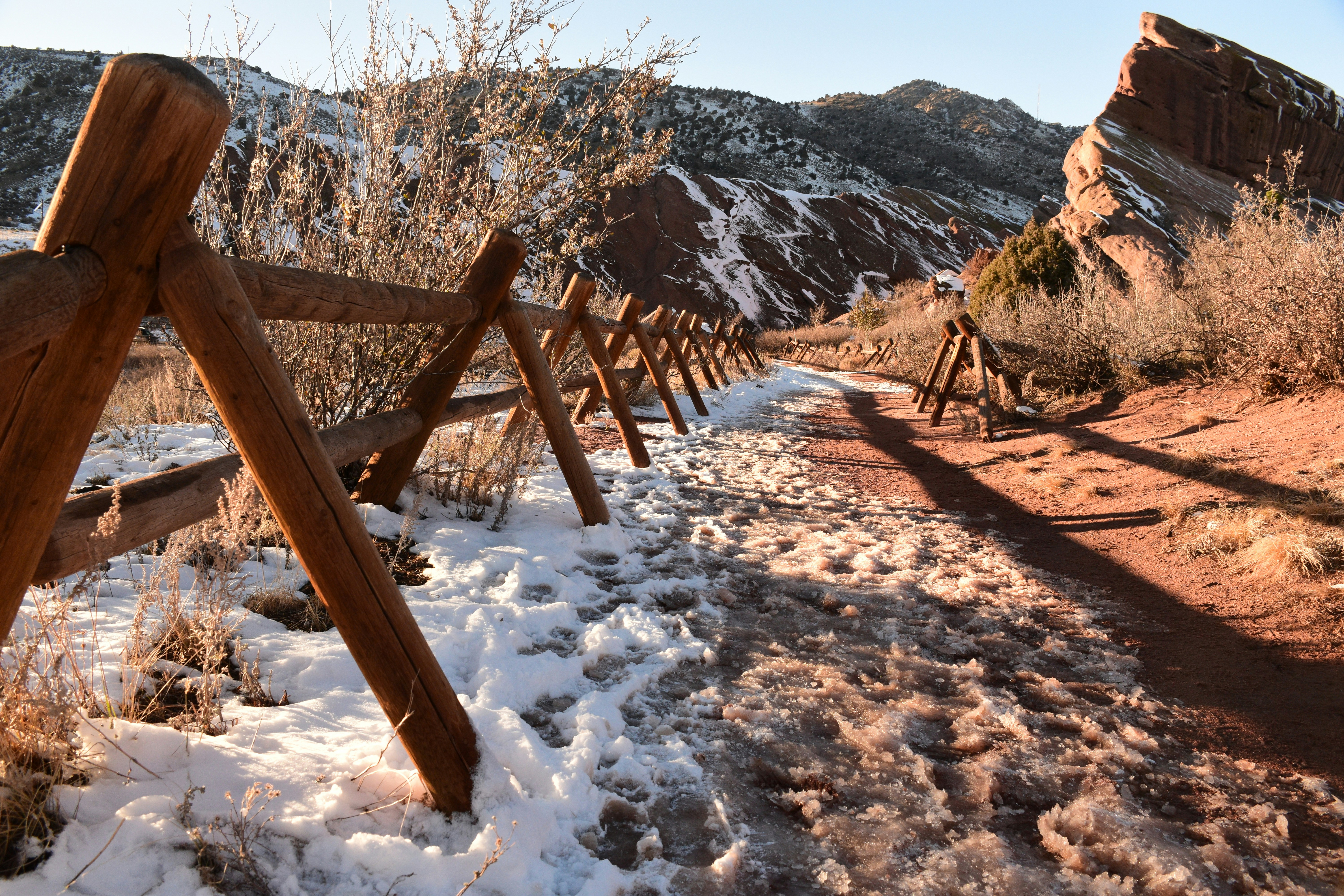 a wooden fence in the snow