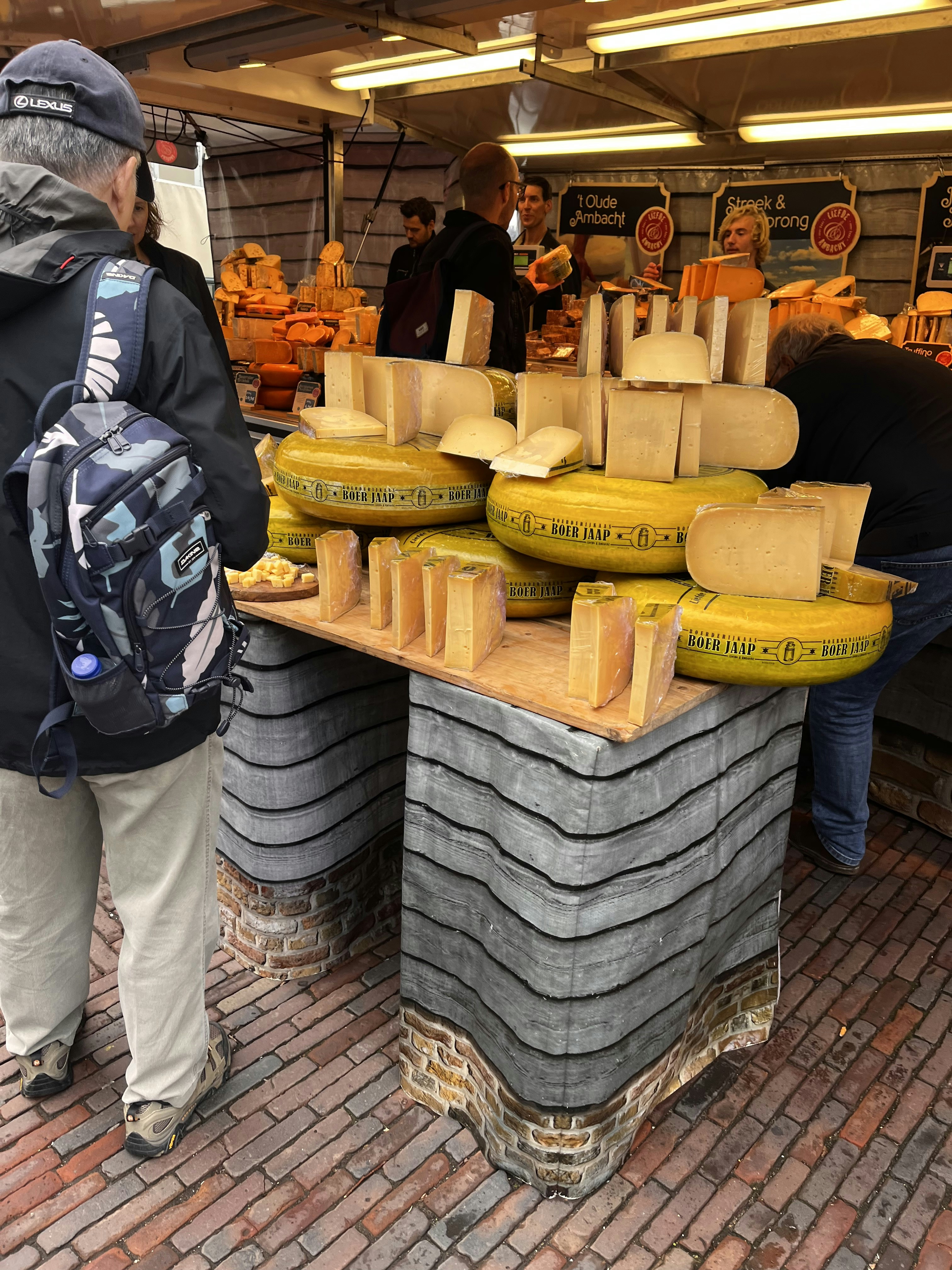 a group of people stand around some tires