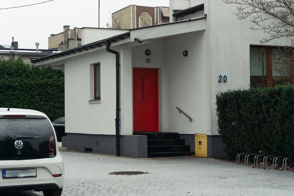 a white building with a red door