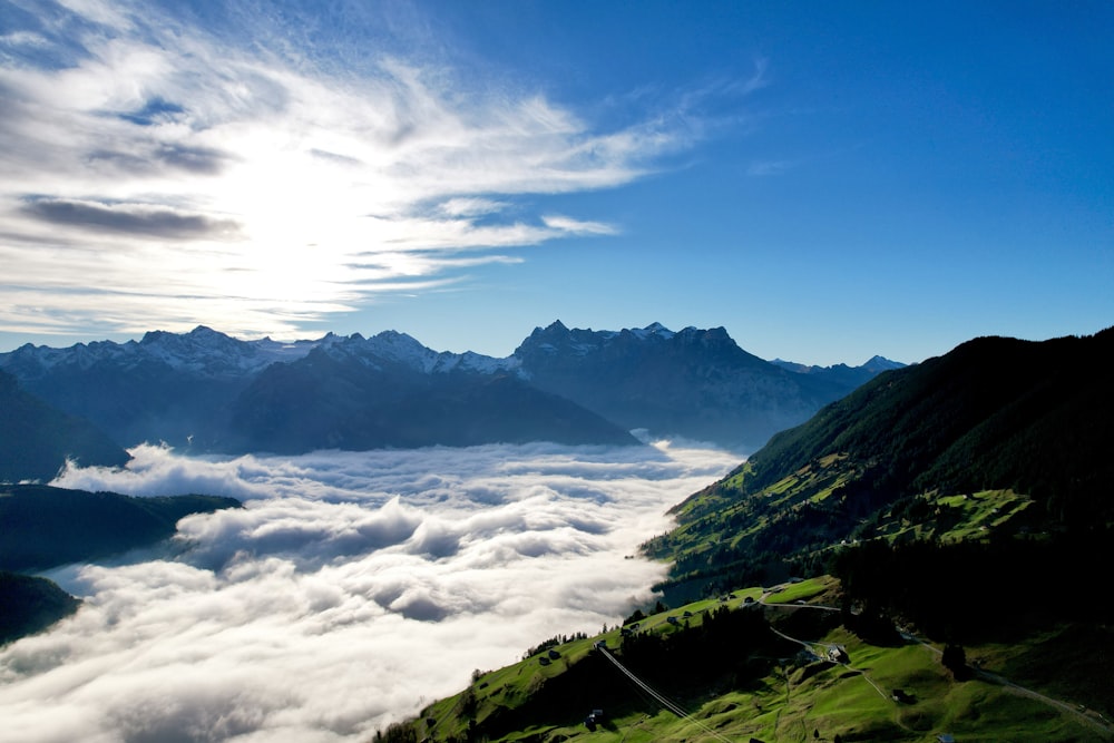 a valley with clouds and mountains