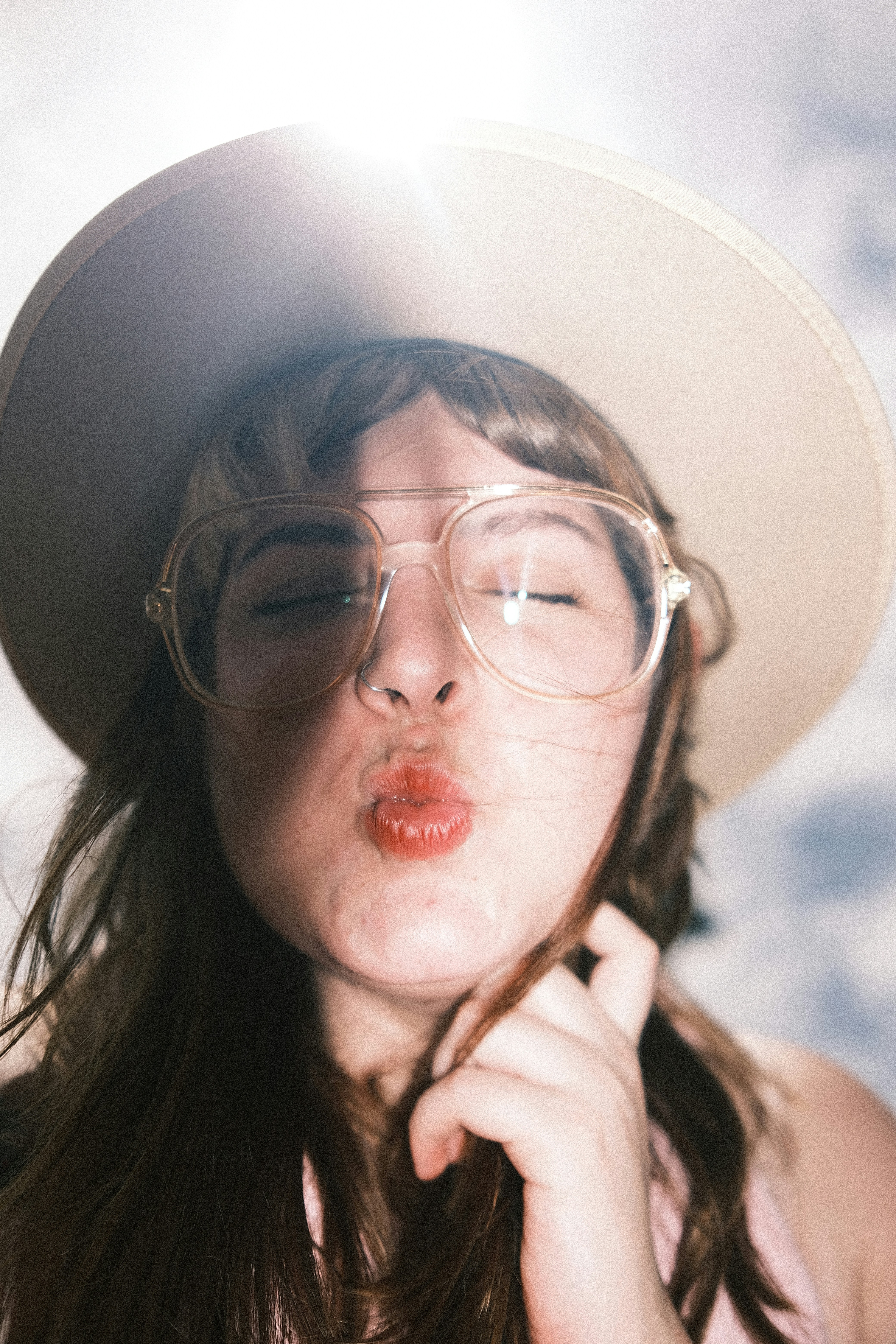 a woman with glasses and a hat