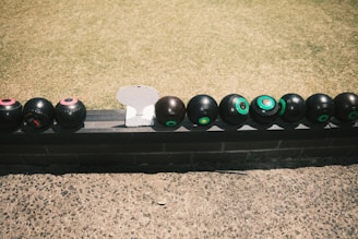a black rectangular object with black balls on it