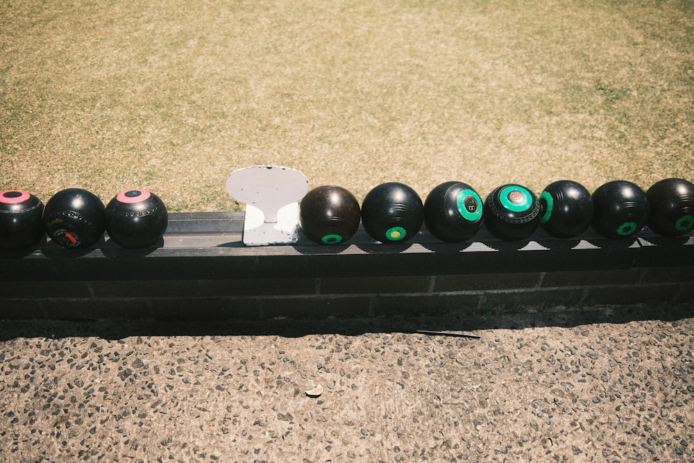 a black rectangular object with black balls on it