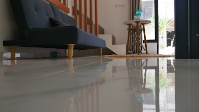 a table and a chair in a room with a window
