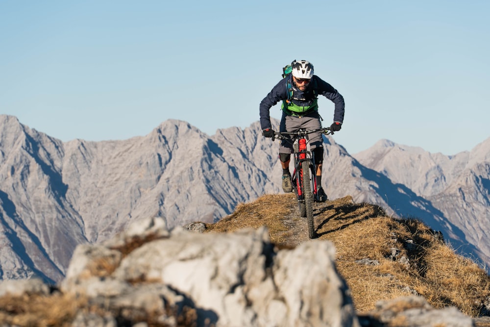 a man riding a bike on a mountain