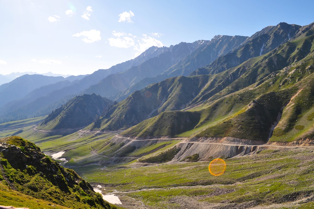 a valley with mountains in the background