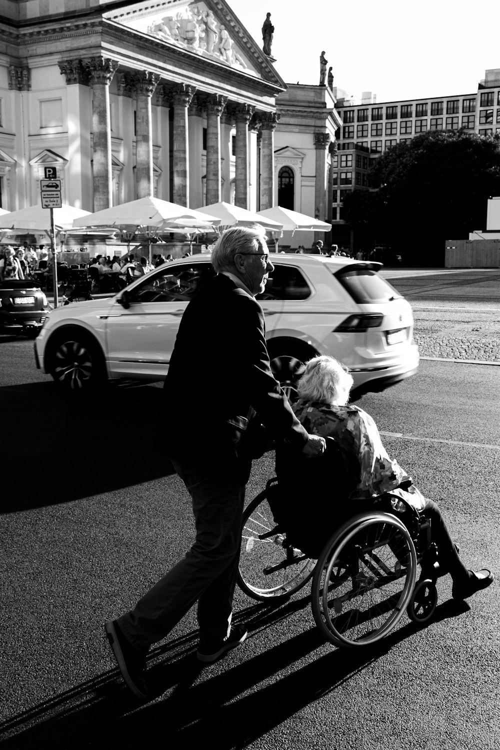 a man pushing a woman in a wheelchair