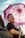 A happy customer holding an umbrella in the rain.