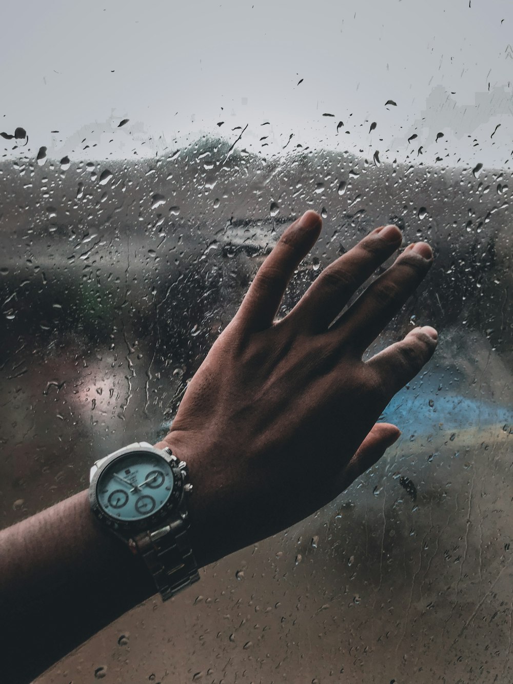 a hand with a watch on a beach